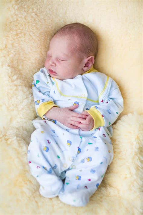 Newborn Baby Boy Sleeping on a Sheepskin Stock Photo - Image of ...