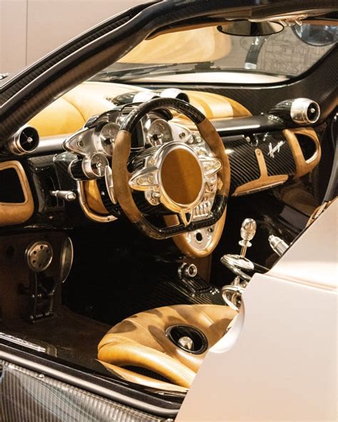 the interior of a sports car with gold and black leather trims ...