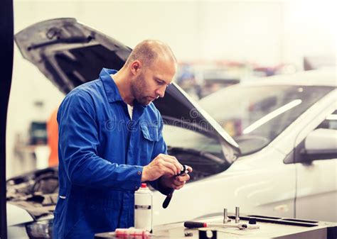 Mechanic Man with Wrench Repairing Car at Workshop Stock Image - Image ...