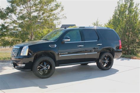 Escalade looks much more truck like after a mild lift and new wheels/tires