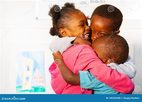 Three Hugging Close Black Kids in Nursery Class Stock Photo - Image of ...