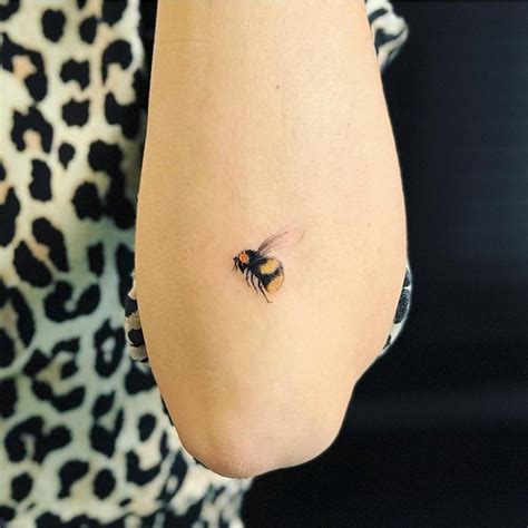 Honey bee tattoo on the left forearm.