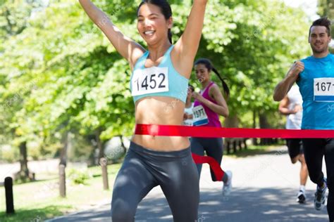 Marathon runner crossing finish line — Stock Photo © Wavebreakmedia ...