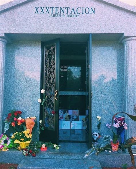 the entrance to an apartment building with flowers and candles on the ...