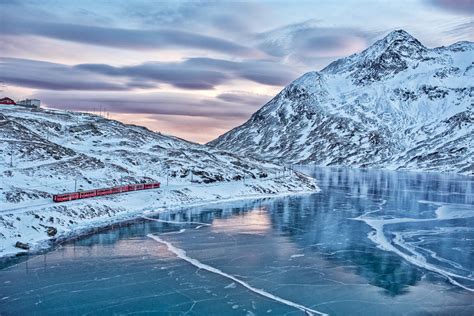 A train passes Lago Bianco in Switzerland : r/WinterFans