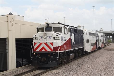 a train traveling down tracks next to a building