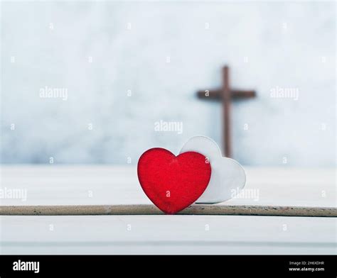 wooden cross and Two red and white hearts on wood background, GOD IS ...