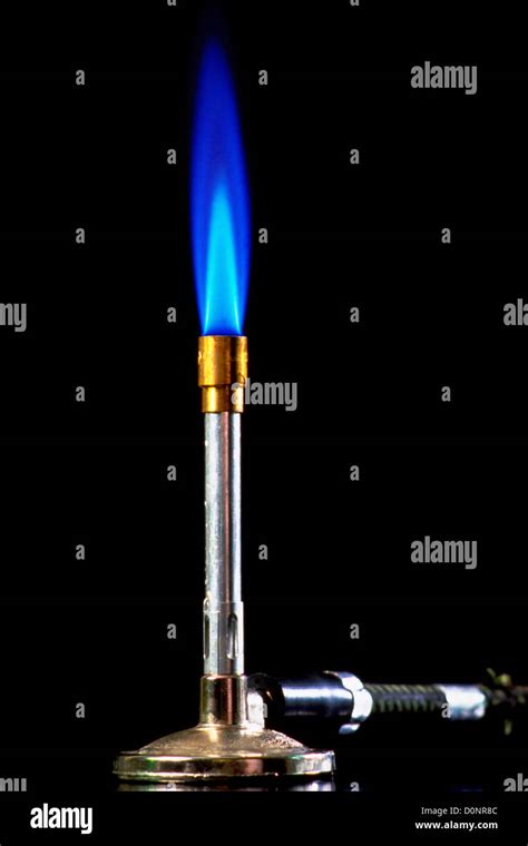 Flaming Bunsen Burner Against Black Background Stock Photo - Alamy