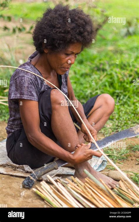 Aeta woman preparing rattan for weaving Stock Photo - Alamy