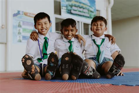 Portrait of Smiling Boys in School Uniforms Sitting on Floor · Free ...