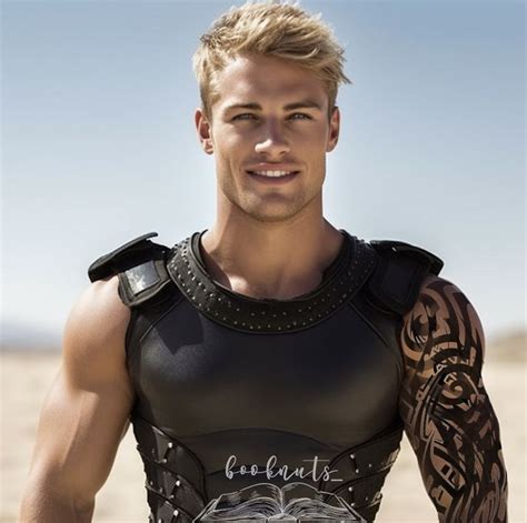 a man with tattoos on his arm and chest standing in the desert wearing ...