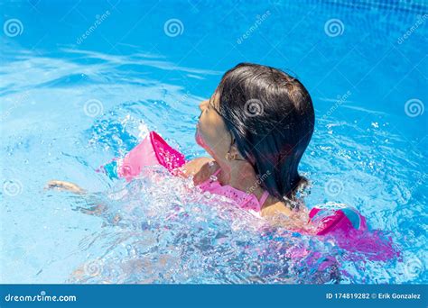 Little Girl Swimming with Floaties Stock Photo - Image of playing ...