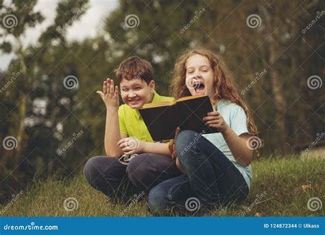 Little Kids Reading the Book Outdoors. Education Concept Stock Photo ...