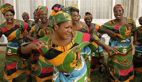 Zambian women sing at Lusaka's international airport in 2008. | Woman ...