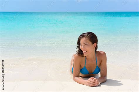 Beach vacation woman relaxing on sand happy. Asian mixed race model ...