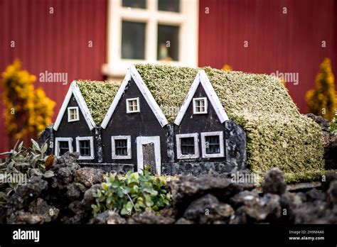 Three small wooden elf houses as a garden decoration in front of a ...