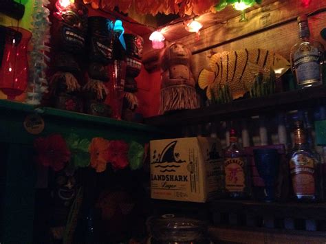 Tiki Hawaiian leas in the backyard tiki bar with tiki statues | Tiki ...