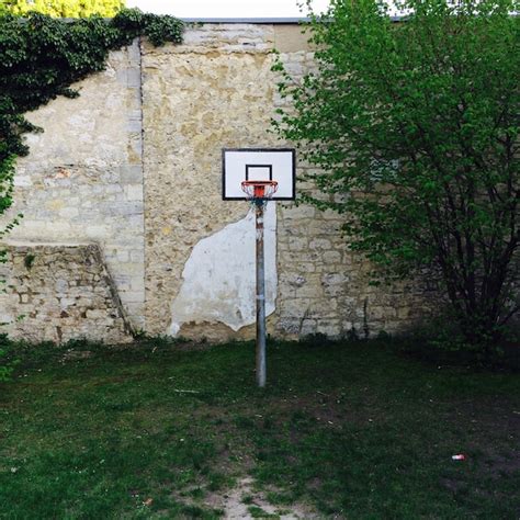 Premium Photo | Basketball hoop at playground against stone wall