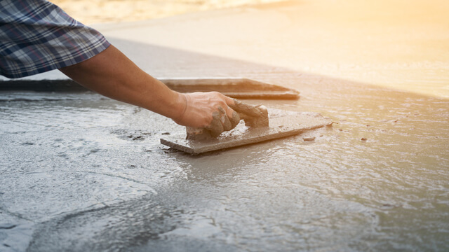 tradie resurfacing the driveway