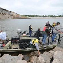 Biologist preparing a shocking boat to go out on the water to collect data.