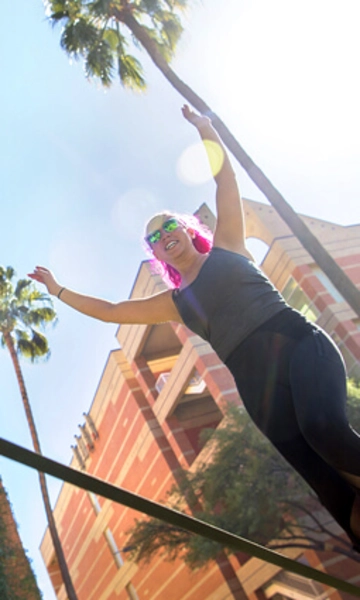 UArizona student on a slackline outside on campus