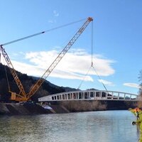 Giant crane places 127t Slovenian steel bridge logo 