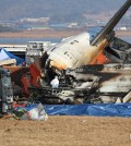 Authorities investigate the wreckage of a crashed Jeju Air plane at Muan International Airport in the southwestern county, 288 kilometers south of Seoul, on Dec. 30, 2024. (Yonhap)