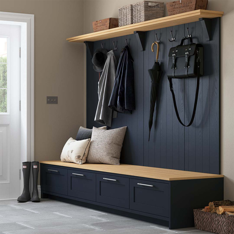 A dark blue boot room unit with wooden accents