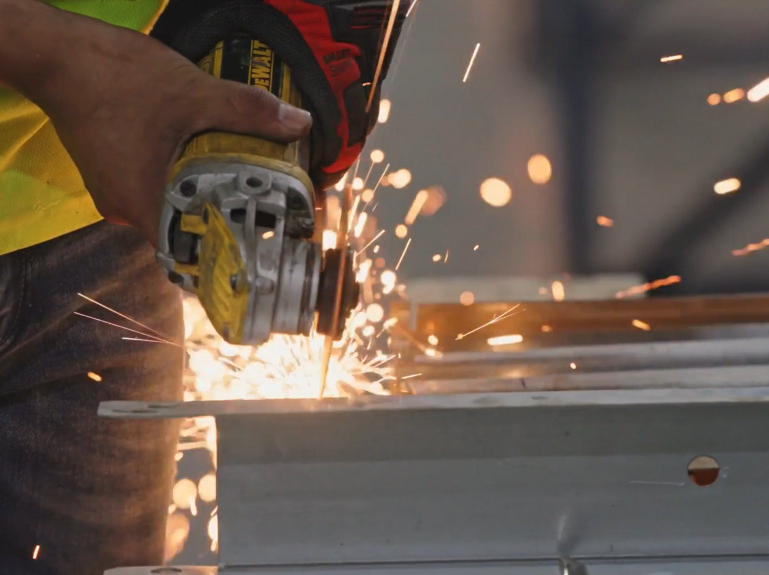 Person using a saw with sparks flying