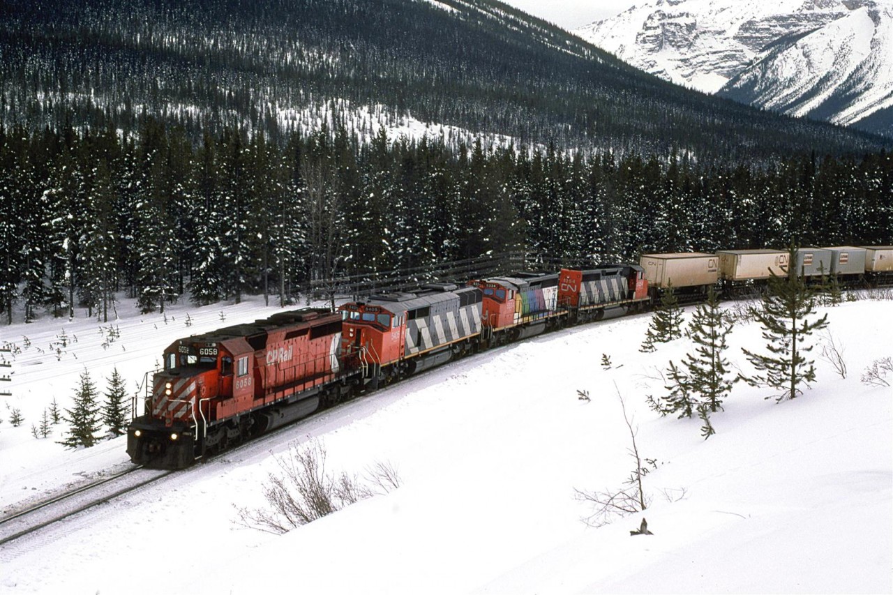 There is a good reason that a CN train is running through Kicking Horse Pass. Their mainline at Hinton is out of service due to the horrific VIA and CN collision. I wasn't in the mountains to catch these detours. I just happened upon this one. We chased it back to Banff, where it became too dark to photograph. Someone would get a photo of this train in one of the popular railfan publications of the time. I did not see them, however.
Note thare was a Cowled unit and the (or one of the) Expo '86 SD-40's in the CN consist. At the time, a pilot engine from the host RR was necessary.