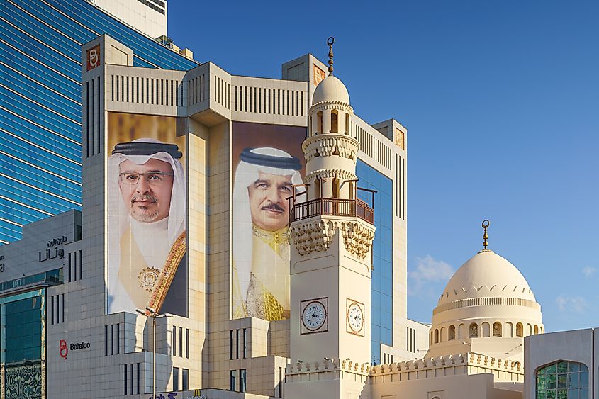 Skyscraper with portraits of Bahraini leaders near Yateem Mosque, Manama, Bahrain. Image Credit Sergey Bogomyako via Shutterstock.