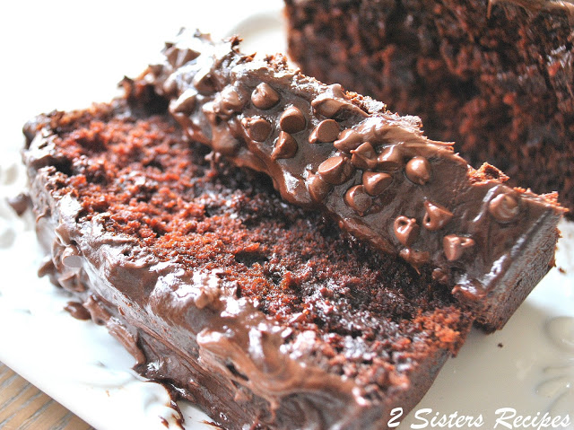 A chocolate bread sliced on a white platter.