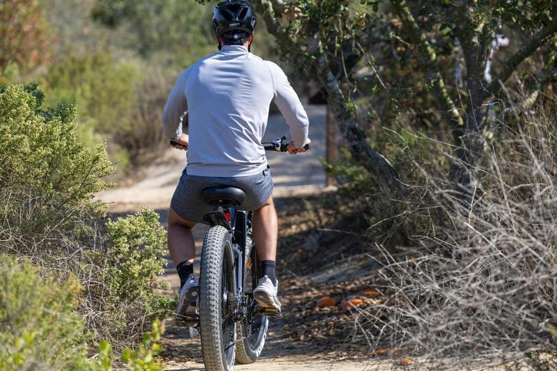 person riding bike on dirt path