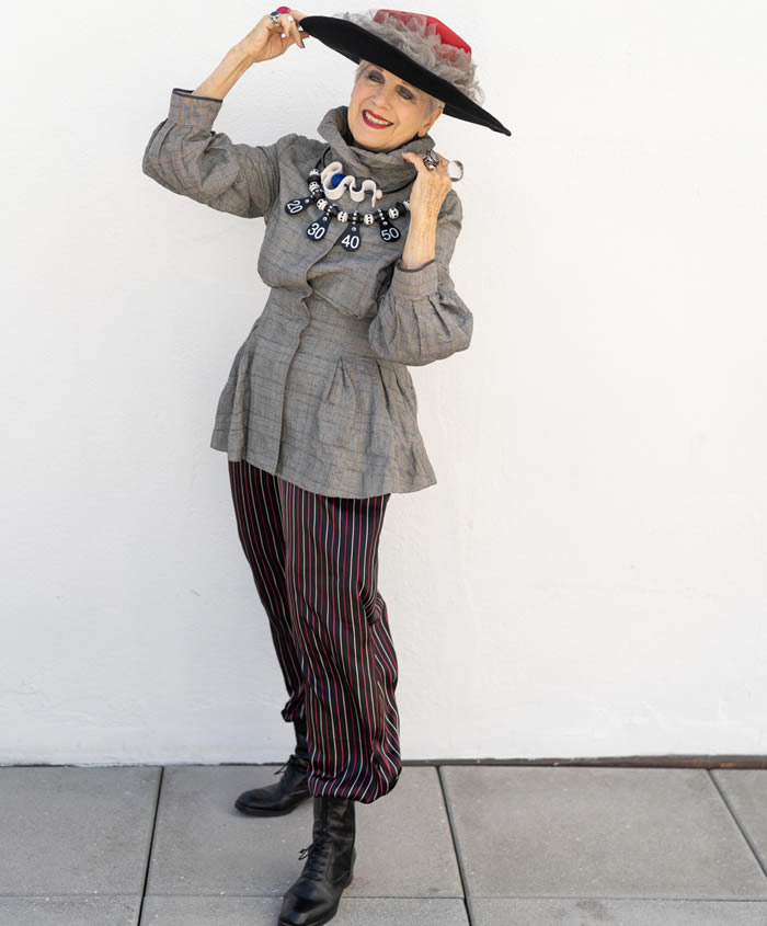 Debra Rapoport wearing a gray jacket with striped pants | 40plusstyle.com