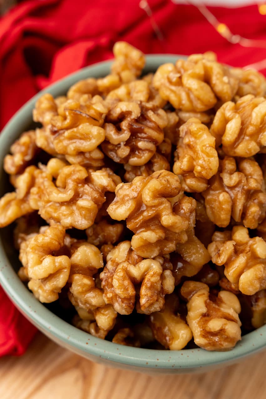 slow cooker maple walnuts in a small gray bowl