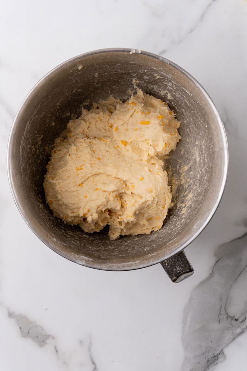 cheesy potato roll batter in a metal mixing bowl