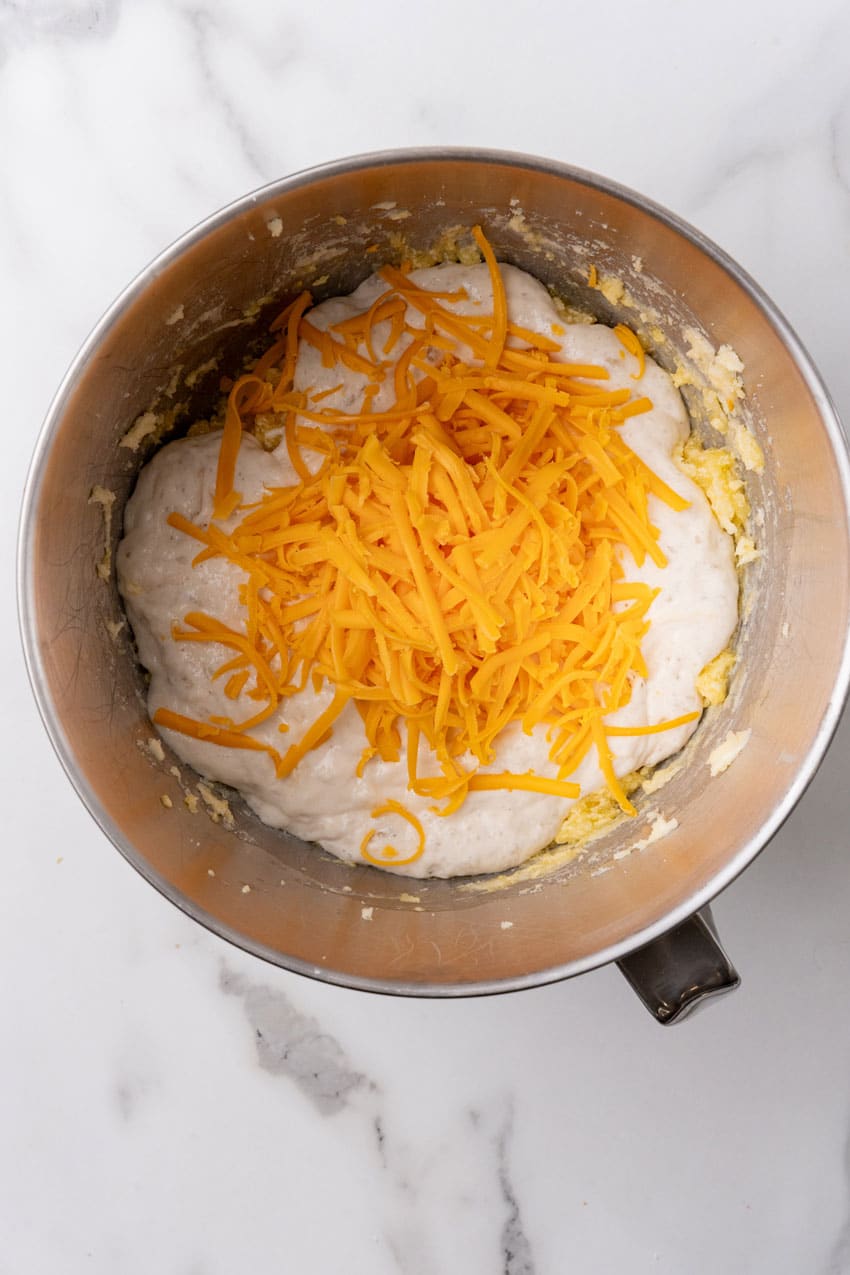 cheesy potato roll batter in a metal mixing bowl