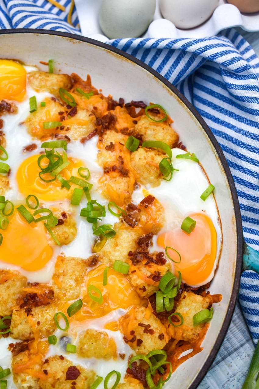 breakfast totchos in a blue cast iron skillet