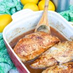 a wooden spoon resting in a casserole dish with pieces of little house on the prairie cinnamon chicken breasts