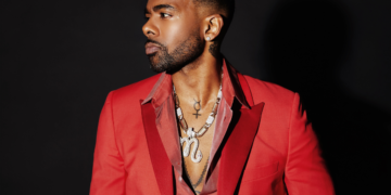 A photo of R&B singer in a red blazer