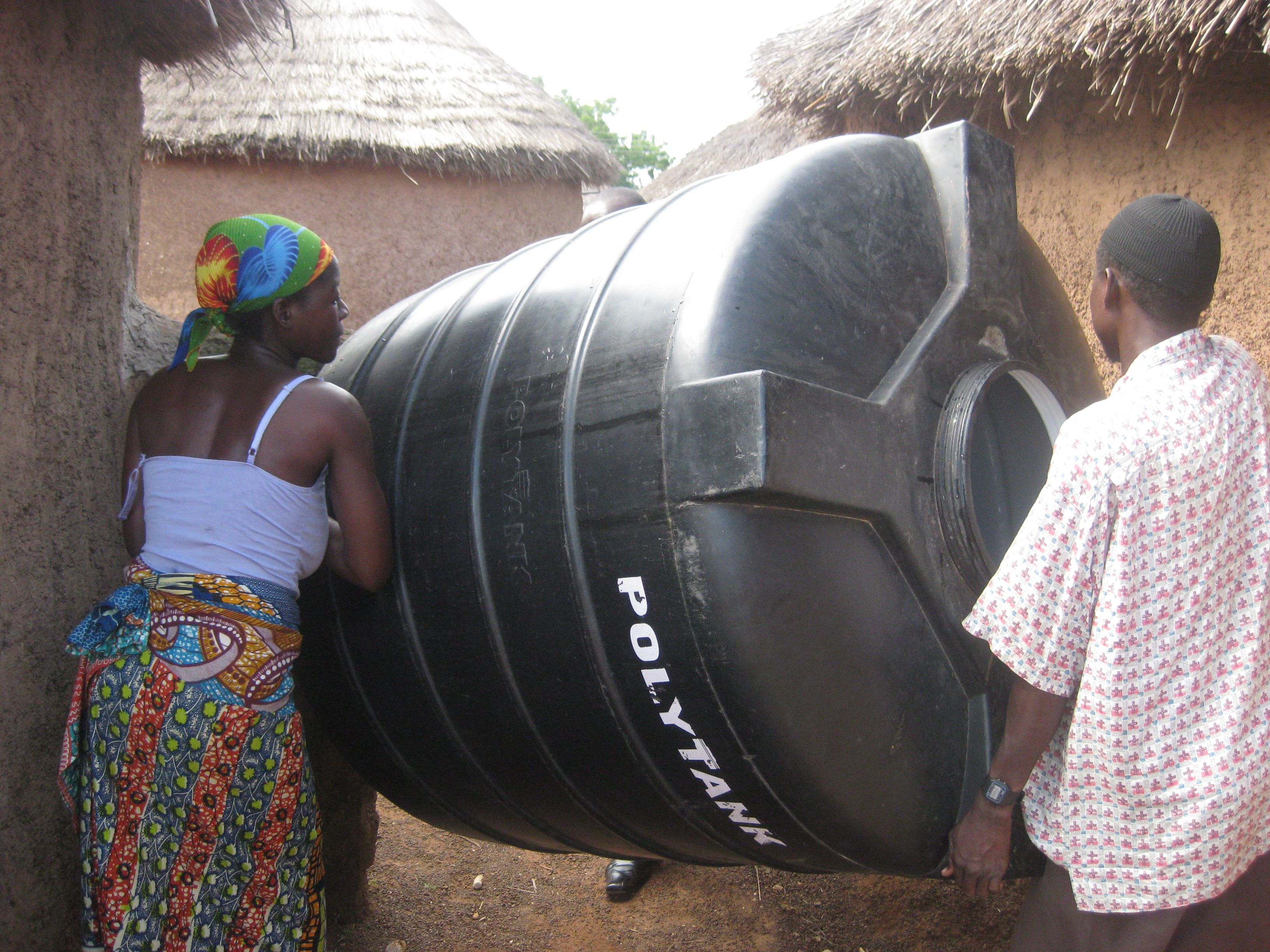 Having a little trouble fitting the polytank through the door at Fati's house...