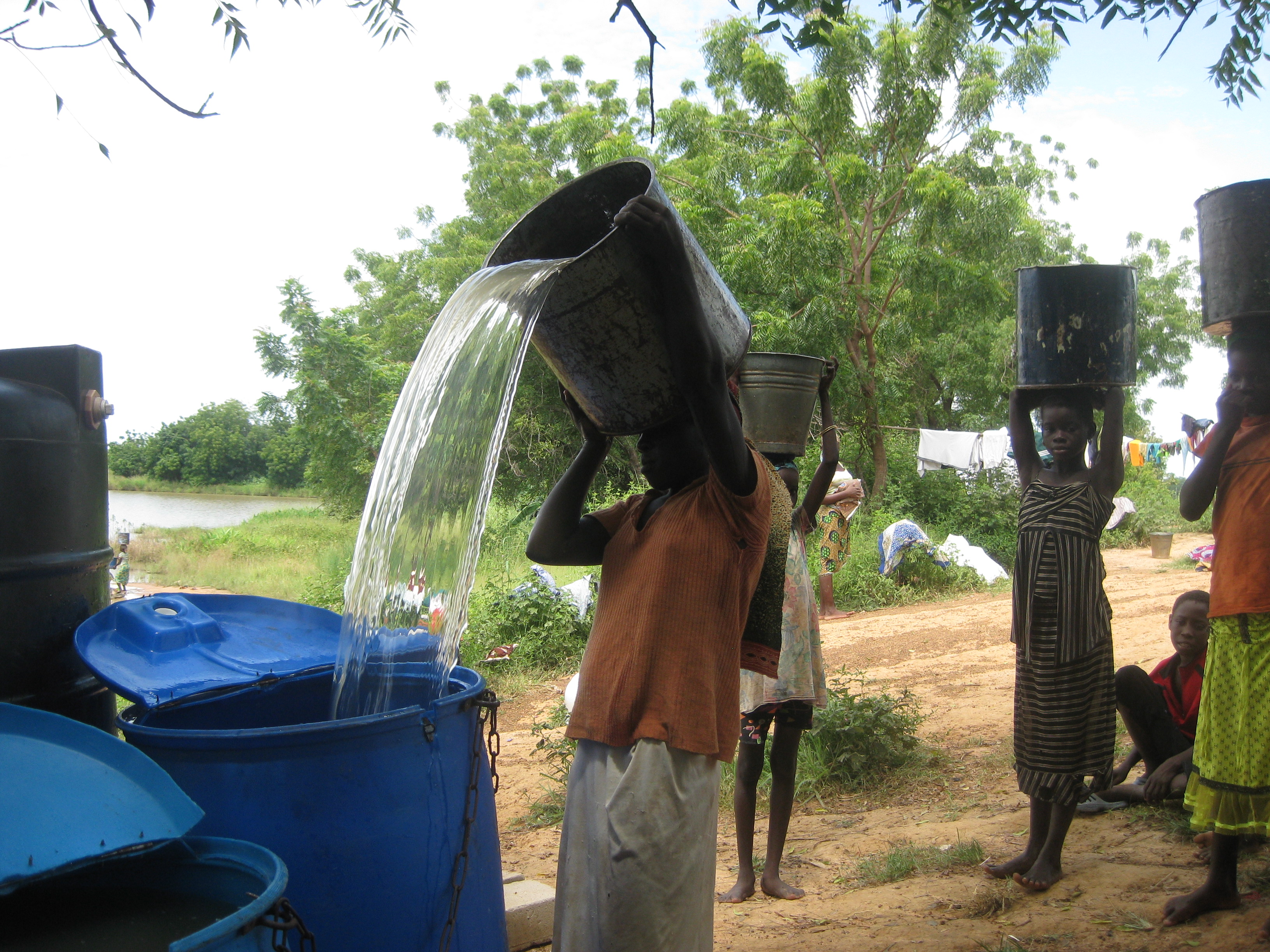 Filling the blue tubs with dugout water