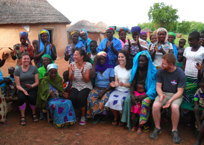 The team clapping along with the women of the village during the appreciation song.