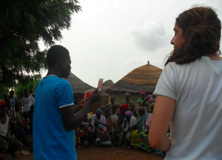 Angie and Nestor presenting the results of the 3M bacteria test to the village at the community meeting.