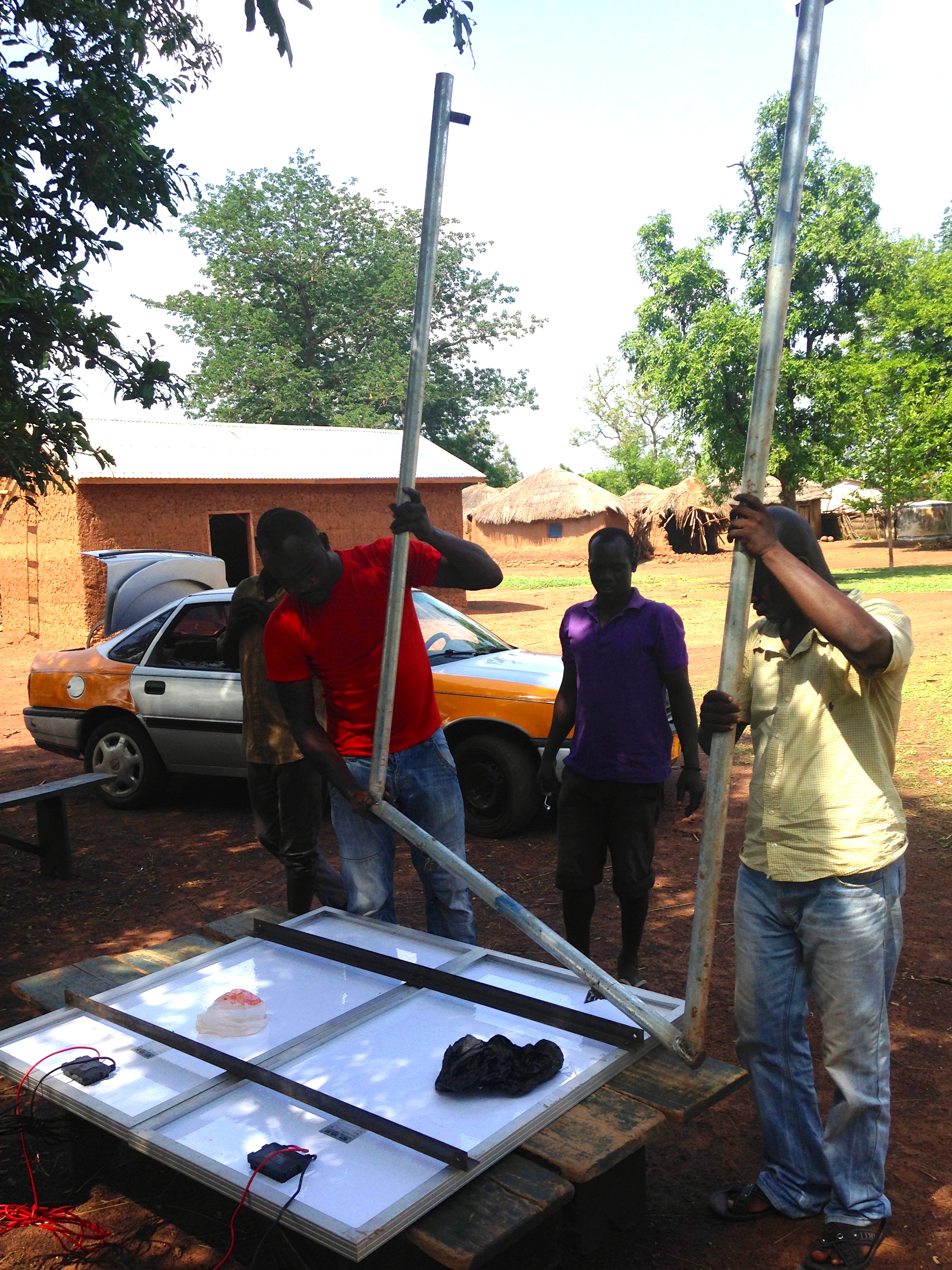 Connecting the solar panels to poles.