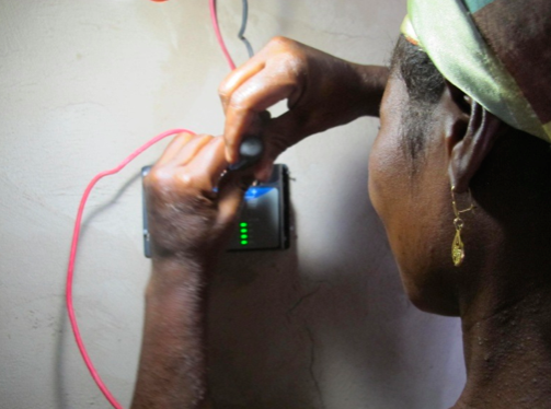 Sana learns to connect the solar panels wires to the microcontroller.