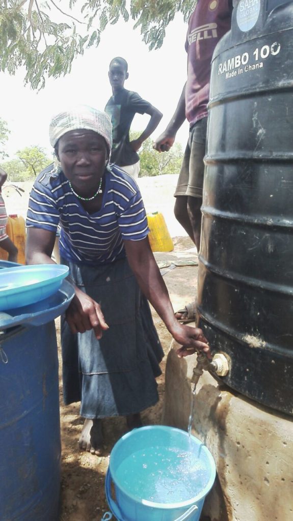 Sanatu makes sales in Kpenchilla. The polytank was leaking but Eric helped fix the problem