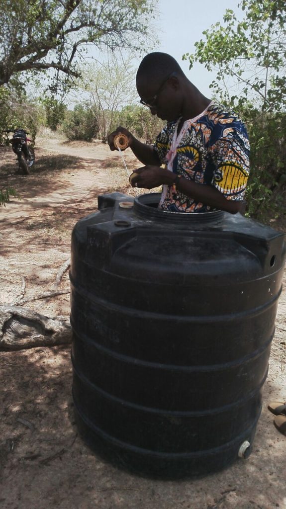 "Sun was scortching, so I brought the polytank under some shade to fix" - Eric in Kpenchila