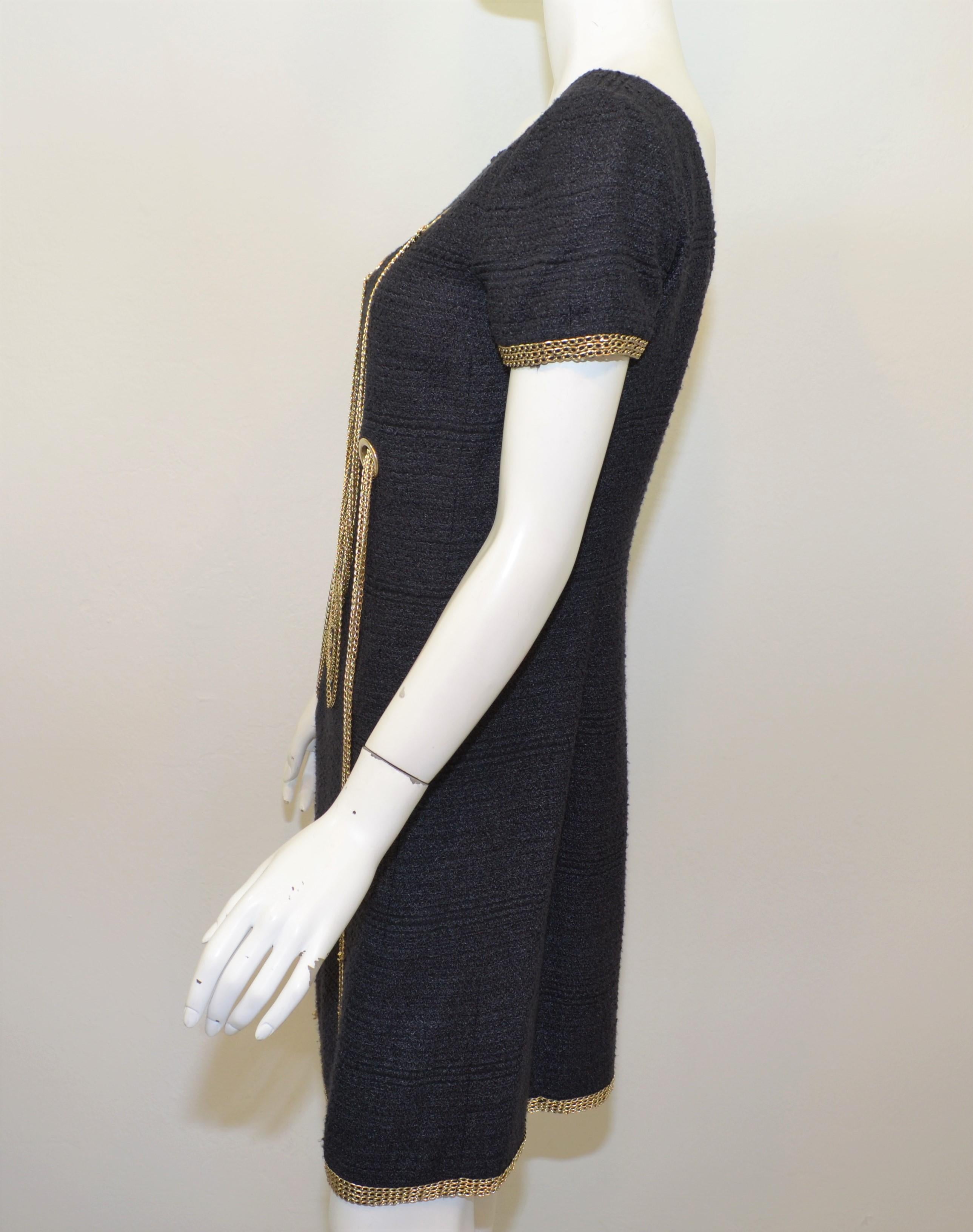 2008 Chanel Tweed Dress with Chains featured in a Navy Blue / black tweed with champagne-tone chain detailing. Dress is fully lined and has a back zipper fastening. Labeled size 38, made in France, composed with a blend of silk, nylon, and wool