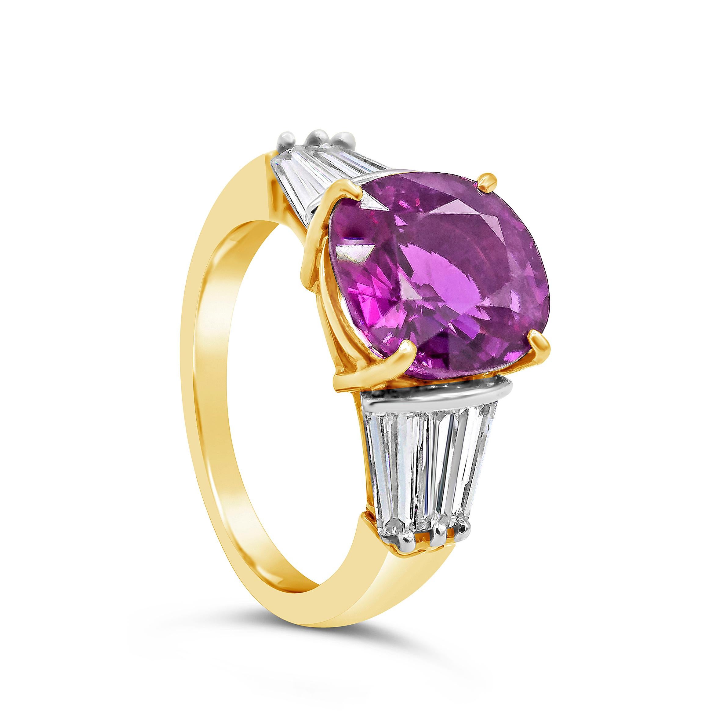 A gorgeous engagement ring, showcasing a natural and vibrant 4.95 carats no heat purple pink sapphire with VVS clarity, set on a classic four prong setting. Flanked by three invisibly set tapered baguette cut diamonds weighing 1.15 carats total.